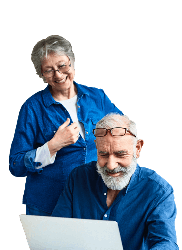 A couple smiling while looking at a computer screen